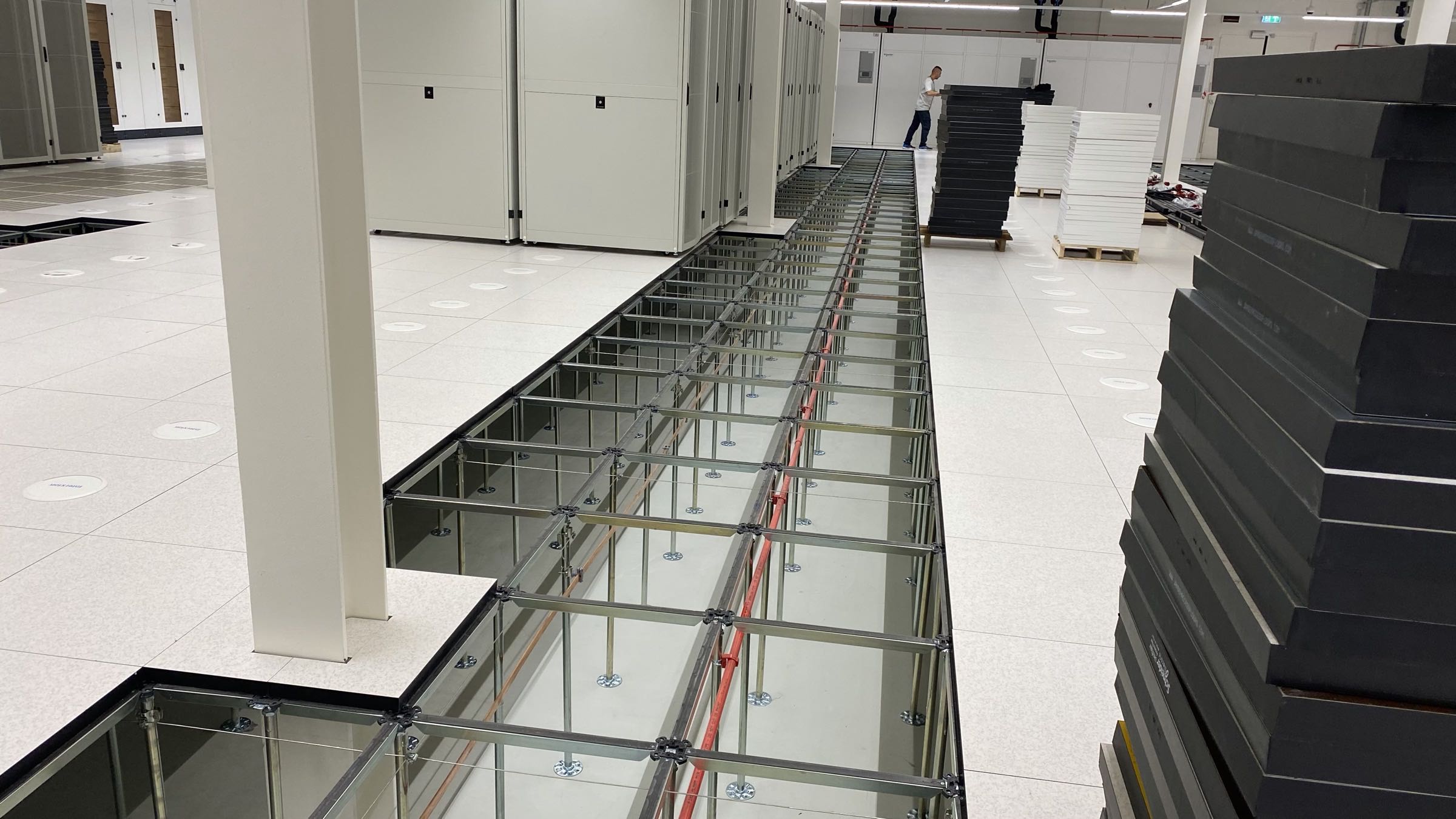 Verhoogde computervloer in datacenter met gestroomlijnde panelen en toegankelijke kabelruimte eronder