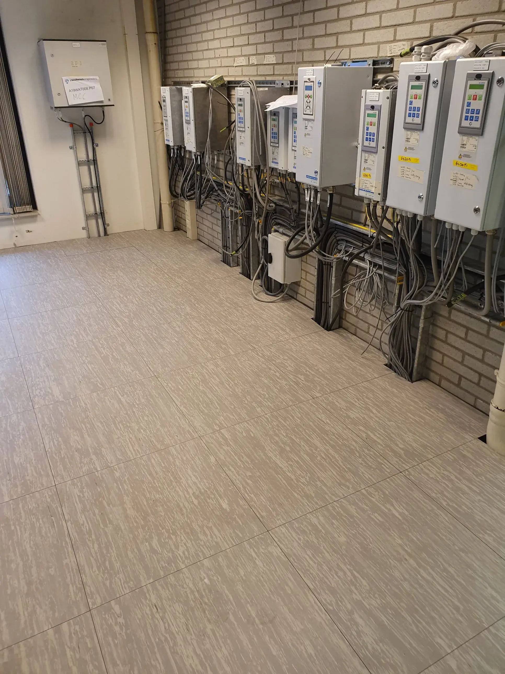 System floor in the switch room of a water treatment plant, with cable entry to the frequency drives, by Anomalie